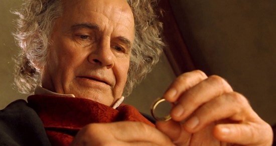 Bilbo (Ian Holm) examines the ring 