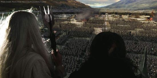 Saruman (Christopher Lee) and Grima (Brad Dourif) atop Isengard looking over the army